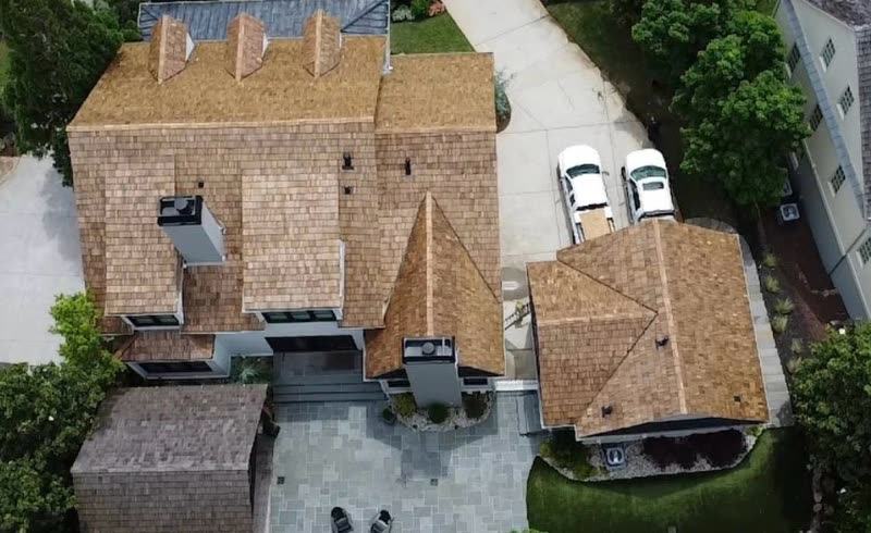 Overhead view of a cedar shake roof wrapping a courtyard entrance