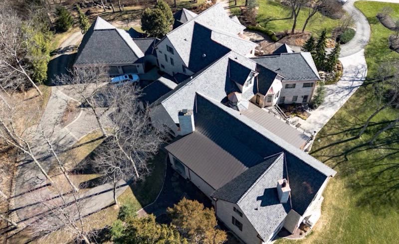 Aerial view of an estate property with several outbuildings, all newly re-roofed