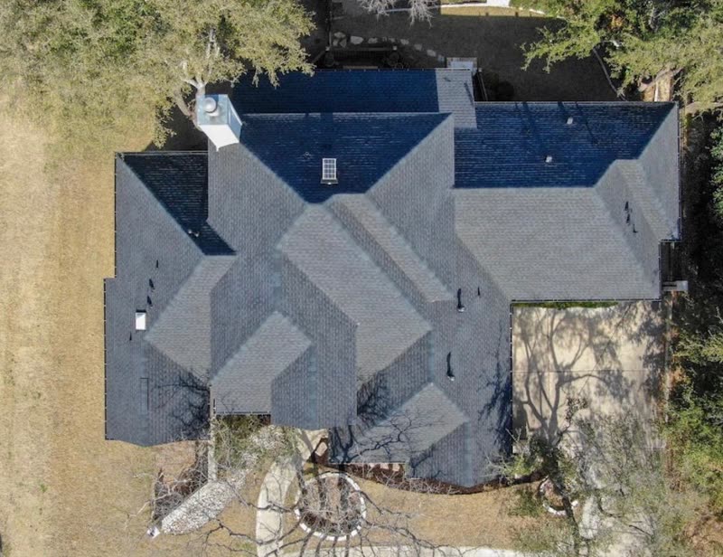 Overhead view of a completed architectural shingle roof across a complex hip layout